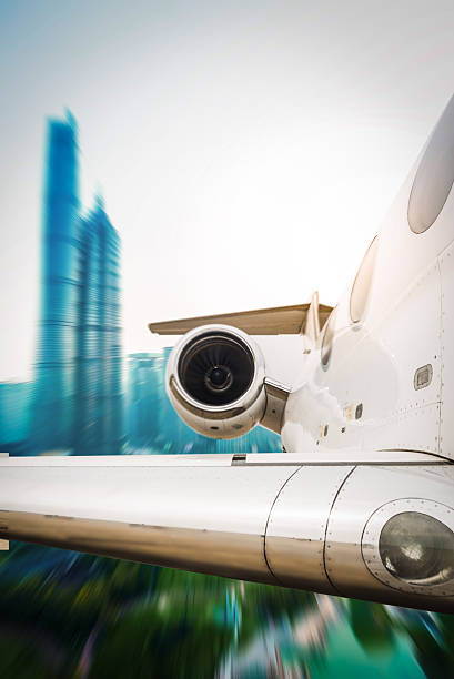 istock Airplane fly above city motion 474689970