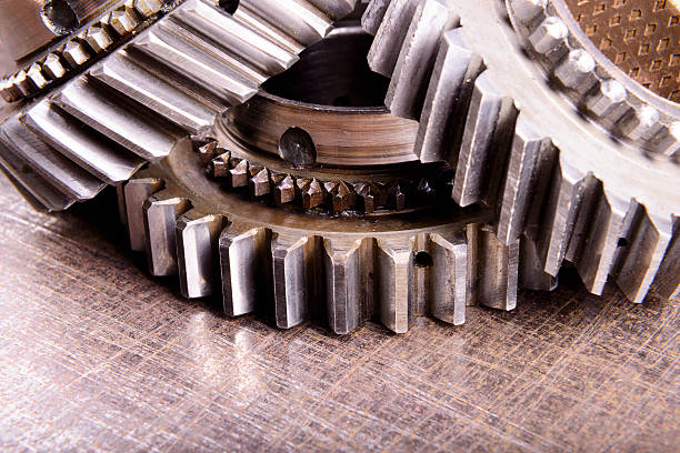 istock gears on metal background 474690780
