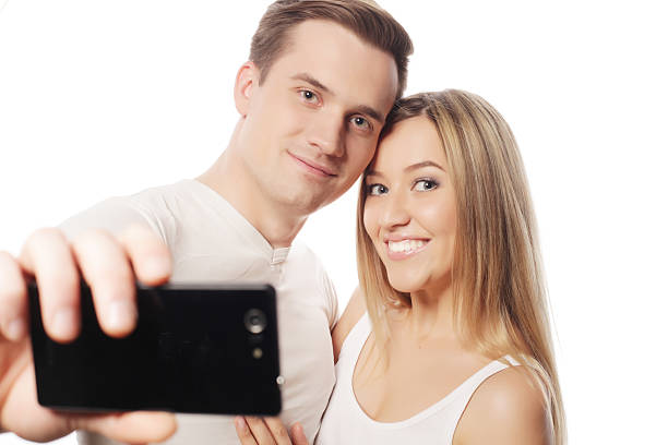 istock smiling couple with smartphone 474693762