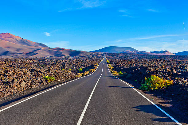 istock Road between rocks  in Timanfaya national Park 474694425