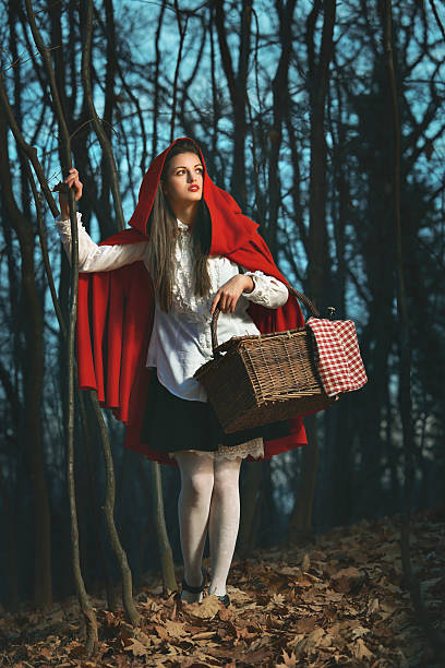 istock Little Red riding hood in the forest at night 474697145
