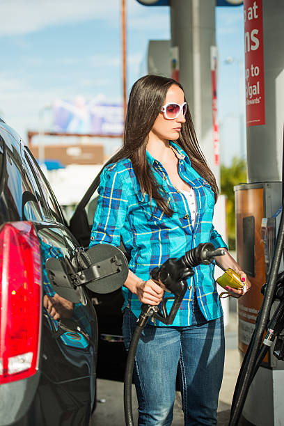 istock Woman with gas hose 474698495