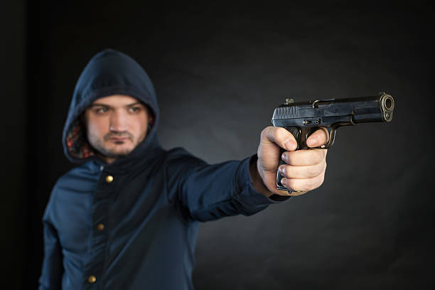 istock Armed man is pointing a handgun at the target. 474702448