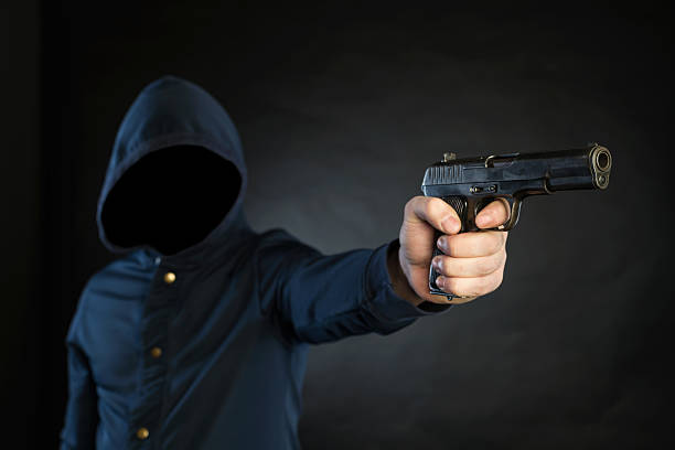 istock Armed person is pointing a handgun at the target. 474702490