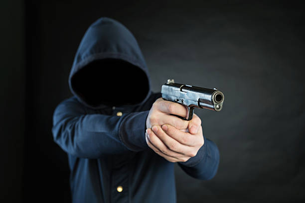 istock Armed person is pointing a handgun at the target. 474702492