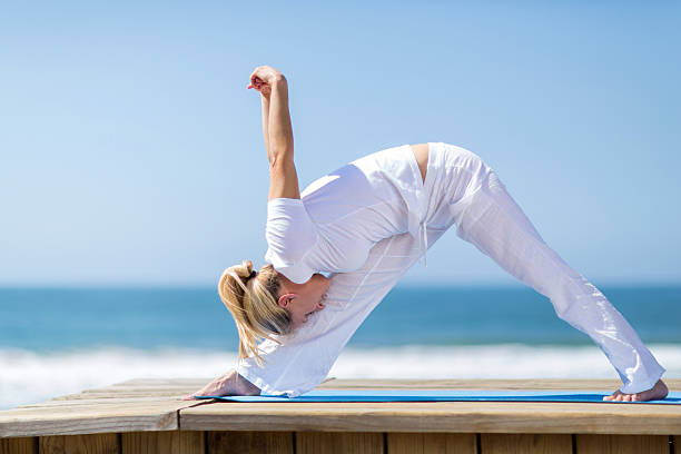 istock mid age woman doing yoga pose 474703993