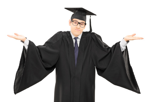 Uncertain student in graduation gown gesturing with hands isolated on white background