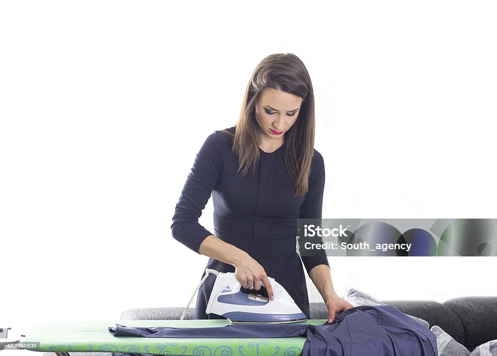 Happy young beautiful woman ironing clothes Happy young beautiful woman ironing clothes. Housework Adult Stock Photo
