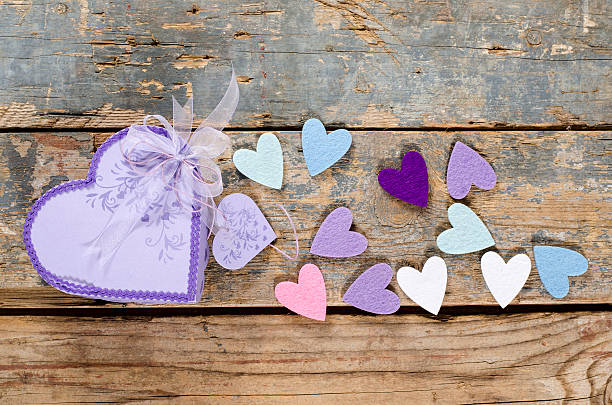 Heart shaped Valentines Day gift box on old wood. stock photo