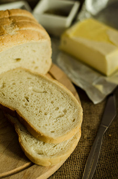 slices of fresh bread with butter stock photo