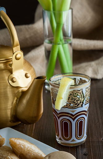 Arabian golden teapot on white wooden table