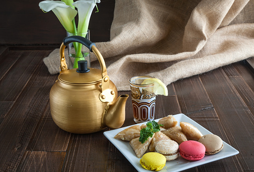 Arabian golden teapot on white wooden tableArabian golden teapot on white wooden table