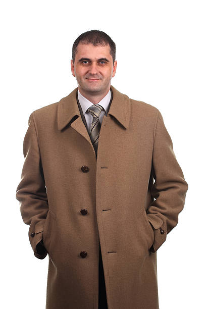 istock Smiling man in light brown coat isolated on white 474714779