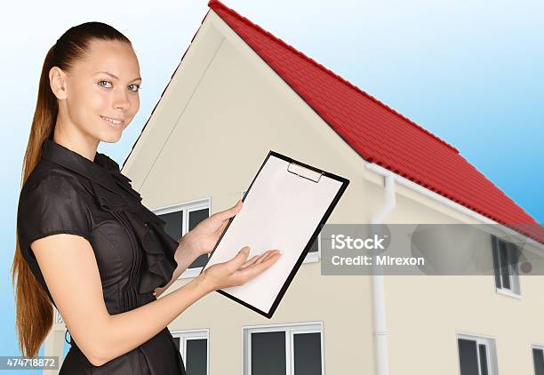 Office Woman Shows Hand In Clipboard Standing On Background Of Stock Photo - Download Image Now