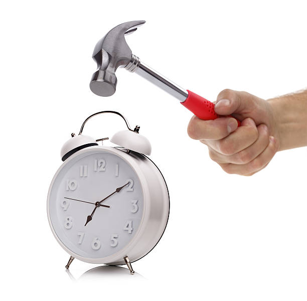 Alarm clock and hammer Hand with hammer about to smash alarm clock in the morning smash alarm clock stock pictures, royalty-free photos & images