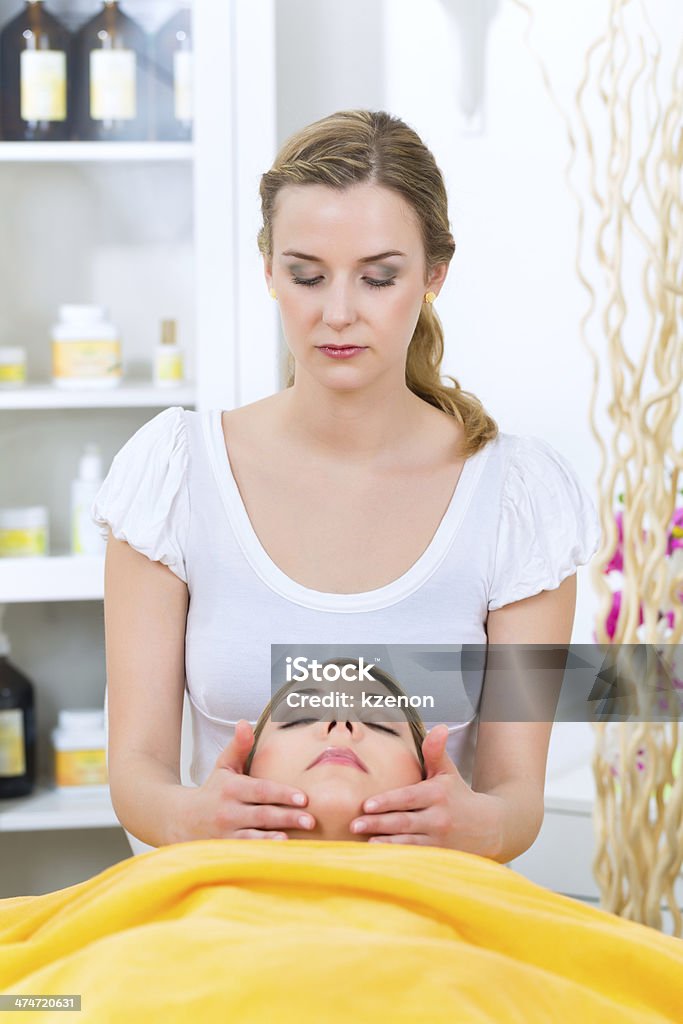 Wellness - woman getting head massage in Spa Wellness - woman receiving head or face massage in spa Adult Stock Photo