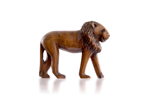 Wood toy lion isolated against a white background