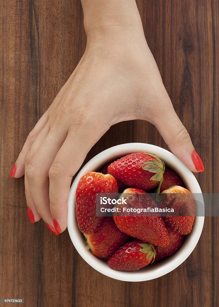 Offering strawberries Woman hand holding bowl full of fresh strawberries Adult Stock Photo