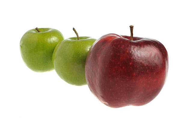 istock Two small green apples over one big red apple isolated 474721863