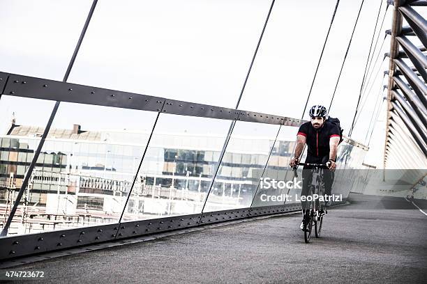 Commuter Cycling Fast At Work In The Morning Stock Photo - Download Image Now - 2015, 30-39 Years, Adult