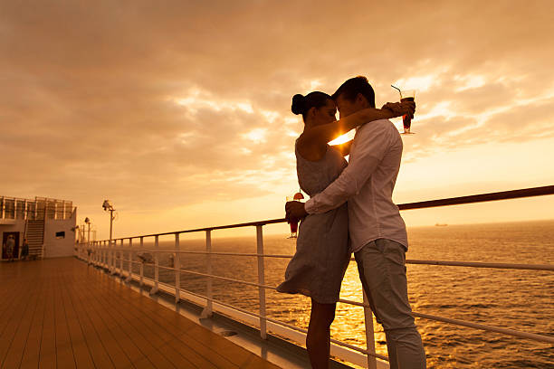 istock couple hugging with eyes closed at sunset on cruise 474725272