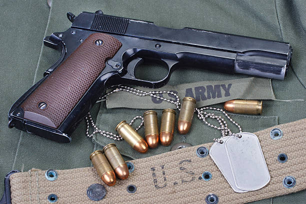 istock colt government M1911 with US ARMY uniform 474725618