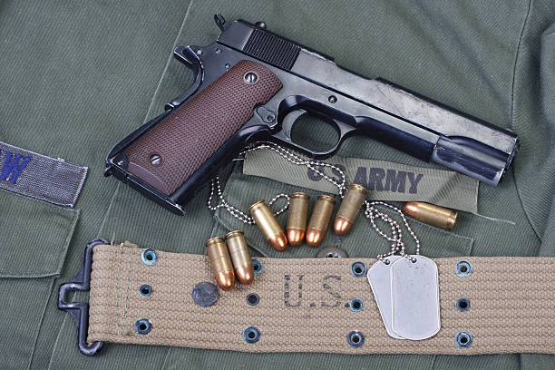 istock colt government M1911 with US ARMY uniform 474725652