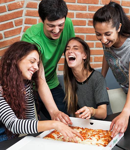 istock Group of People Eating Pizza 474726282