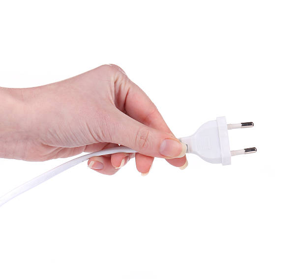 istock hand holds Electric plug and long cable 474728161