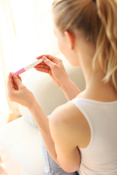 istock Woman holding negative pregnancy test 474730018