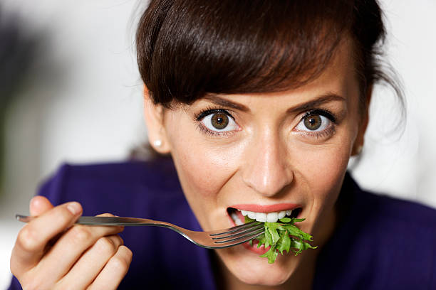 istock Woman eating fresh salad 474730407
