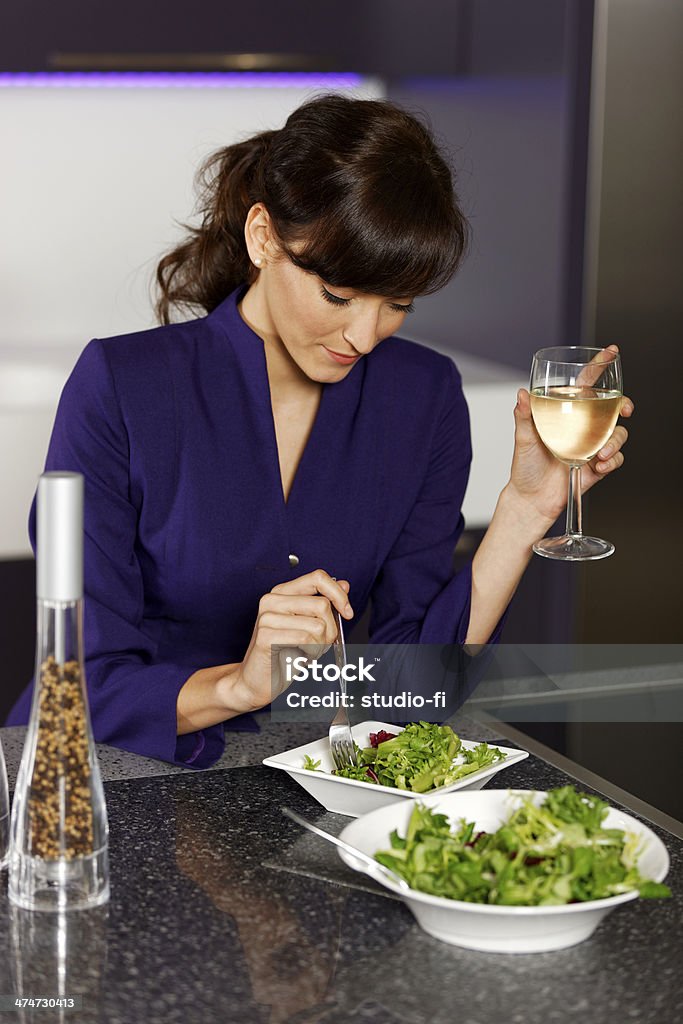 Woman preparing lunch Attractive young woman preparing a healthy lunch after work. Adult Stock Photo