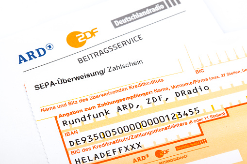Wiesbaden, Germany - May 21, 2015: Bank transfer form for the payment of German radio and television license fee. Formerly known as GEZ the Beitragsservice (fee collection service) von ARD, ZDF und Deutschlandradio is a joint venture of Germany's public broadcasting institutions and responsible for the collection of license fees.