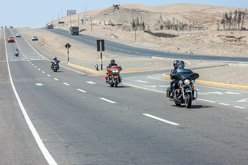 Huaral, Peru - January 22, 2015: Harley Davidson Motorcyclists in convoy on the pan-american highway in Peru