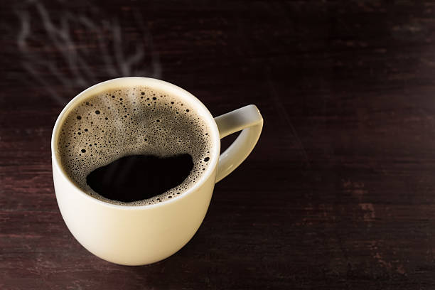istock hot cup of brewed black coffee on wooden table 474732706