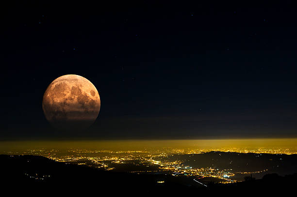 istock Red Moon rises over city lights. 474736684