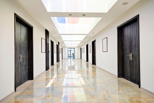 empty hallway, very long corridor with many doors for rooms of hospital, hotel, school or laboratory, building with many office, campus for medical and scientific experiments, research, or teaching