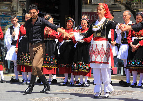 Heraklion, Greece - April 29, 2015: Young Greek dancers perform a traditional Cretan dance in the streets of Heraklion.