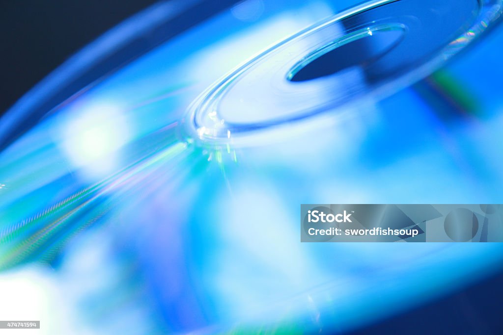 Compact Disc Blue Reflections Compact disc or DVD close up with blue refelections 2015 Stock Photo