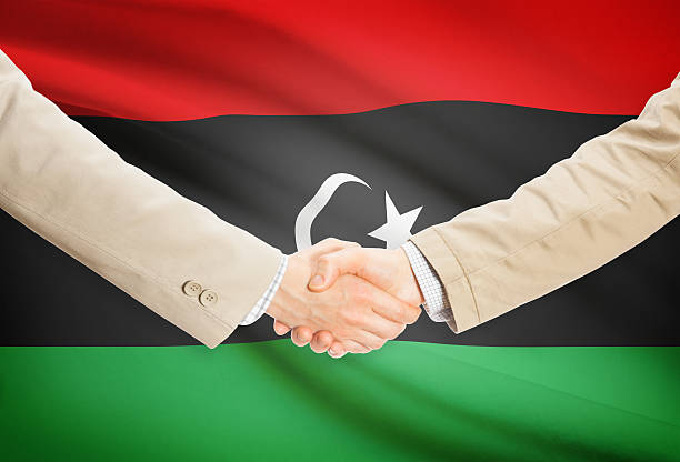 istock Businessmen handshake with flag on background - Libya 474742540