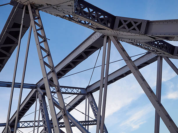 istock Detail of painted riveted bridge against blue sky. 474745378