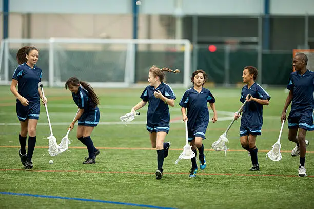 Photo of Young lacrosse team run on field