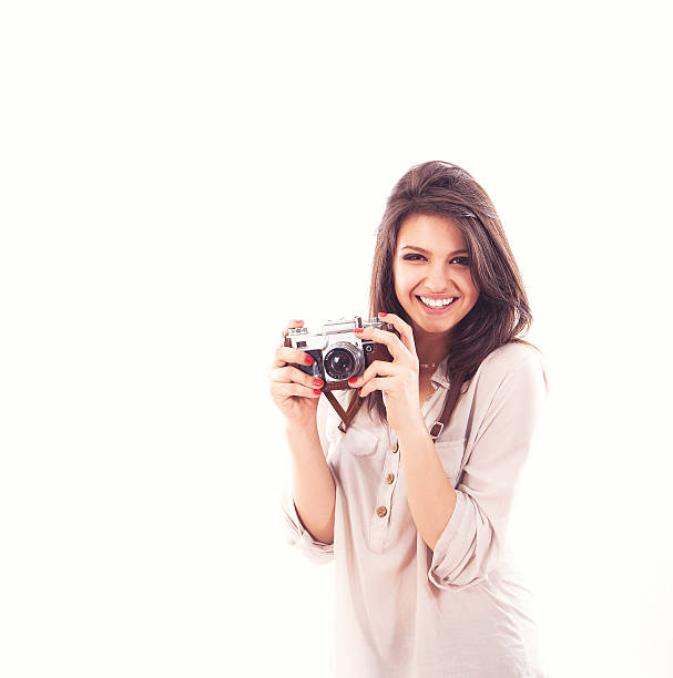 istock Young woman holding a camera 474748127