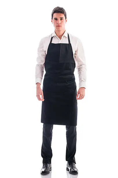 Photo of Full length shot of young chef or waiter posing isolated
