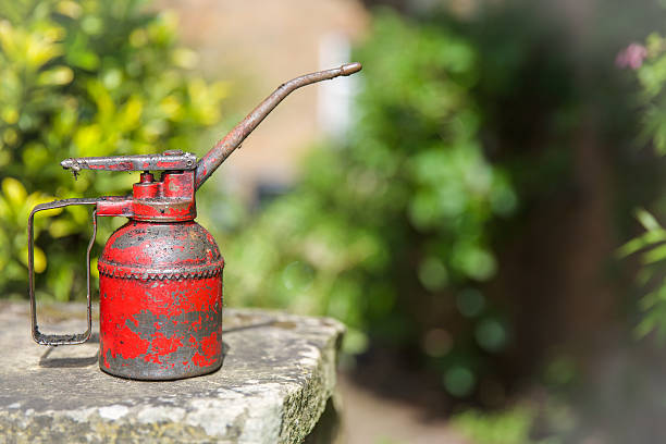 istock Old style oil can with spout and handle in red 474749602