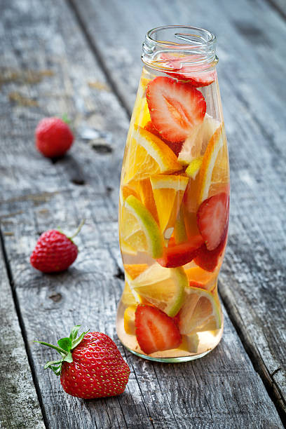 istock Fresh fruit detox water in bottle on wooden table 474749624