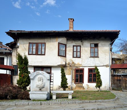 Triavna, Bulgaria - March 1, 2015: Old traditional house in Triavna  and fountain in front of it. Bulgaria, Eastern Europe.