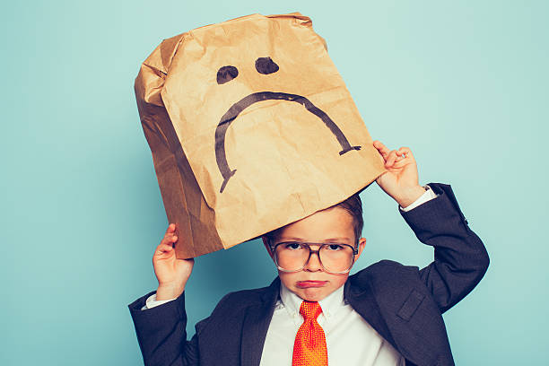 istock Young Boy Businessman Puts a Sad Face On 474749942