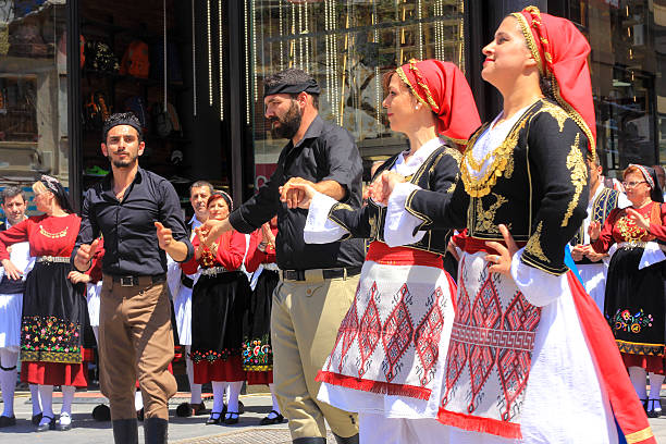 Trikeri, Pelion, Greece - April 13, 2007: Line of women dancing in the platia.