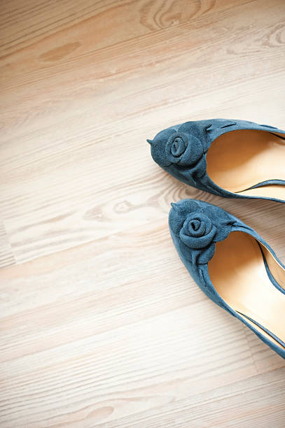 Blue suede leather women shoes Detail of blue suede leather women shoes isolated on white wooden floor. A lot of copy space. Vertical color image. womens blue suede shoes stock pictures, royalty-free photos & images